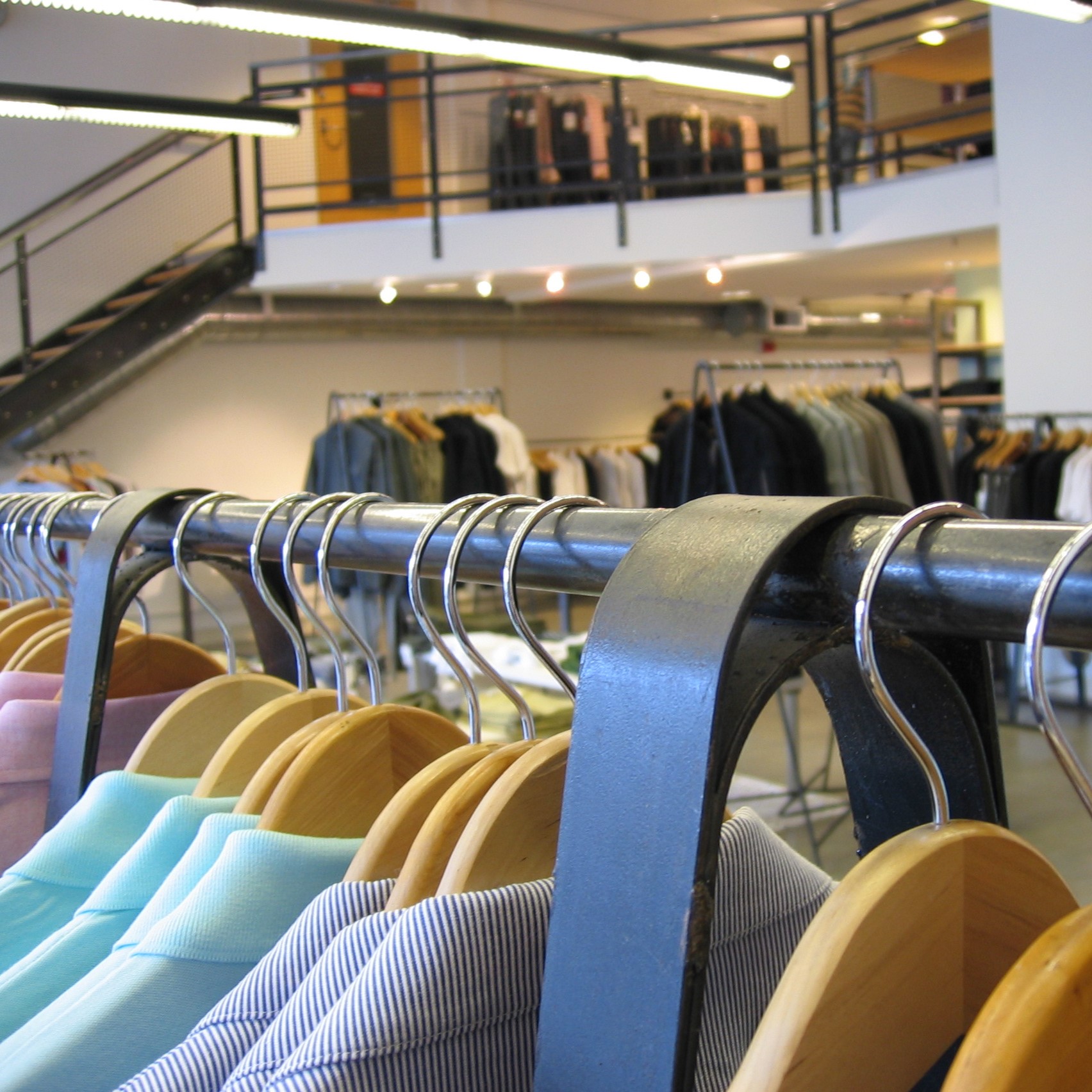 Clothing rack in the foreground of a store.